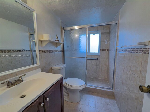 1103 NW 58th Ter Unit 224, Sunrise, FL 33313 - bathroom featuring tile walls, a stall shower, tile patterned floors, vanity, and toilet