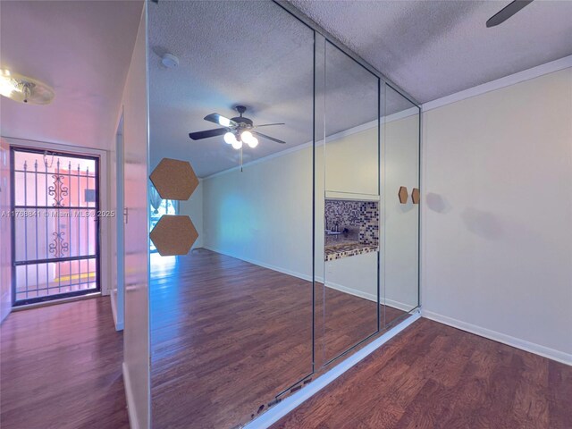 1103 NW 58th Ter Unit 224, Sunrise, FL 33313 - unfurnished bedroom featuring wood finished floors, a textured ceiling, baseboards, a ceiling fan, and vaulted ceiling