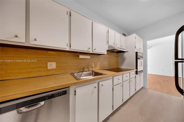 kitchen featuring a sink, oven, dishwasher, black electric cooktop, and under cabinet range hood