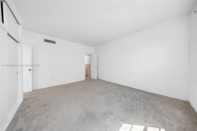 unfurnished room with light carpet and visible vents