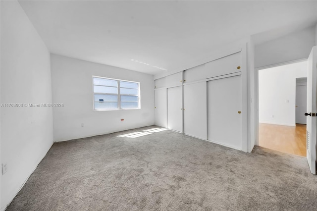 unfurnished bedroom with carpet floors and a closet