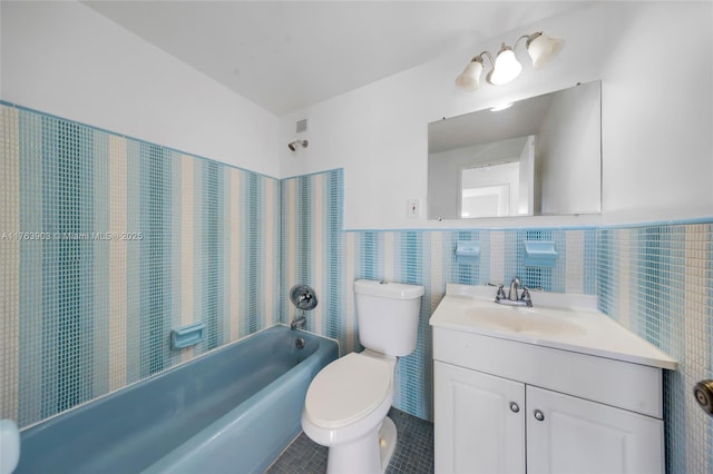 full bathroom featuring tile patterned flooring, shower / bath combination, vanity, toilet, and tile walls