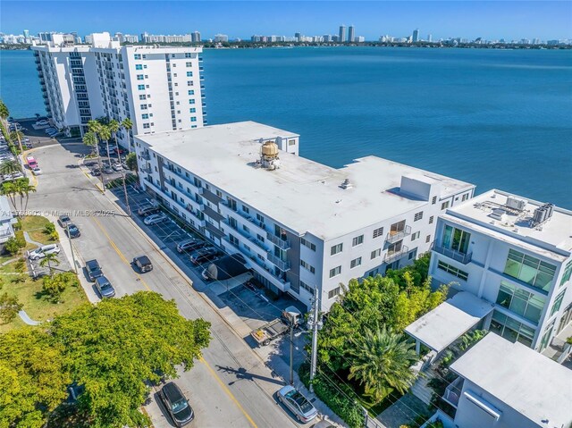 drone / aerial view featuring a water view and a view of city
