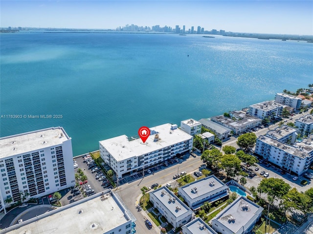 birds eye view of property with a water view and a view of city
