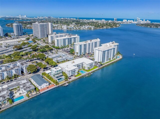 birds eye view of property with a water view and a view of city