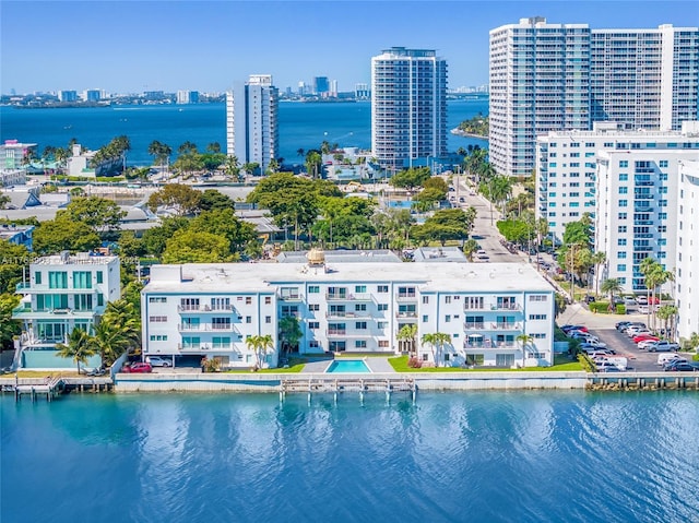 drone / aerial view featuring a city view and a water view