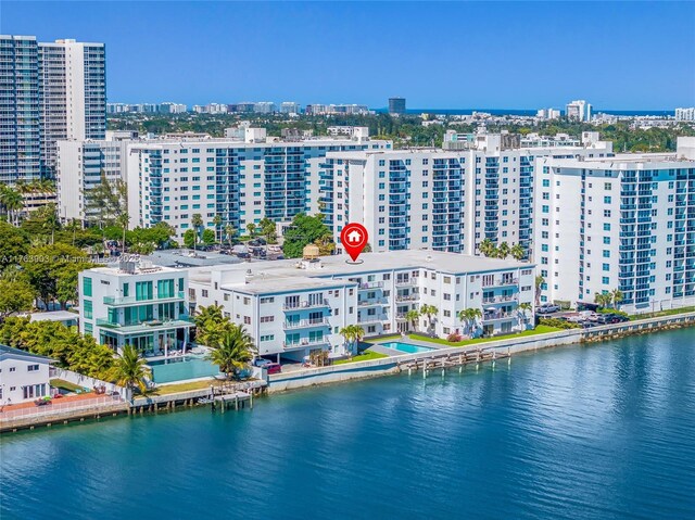 birds eye view of property with a city view and a water view