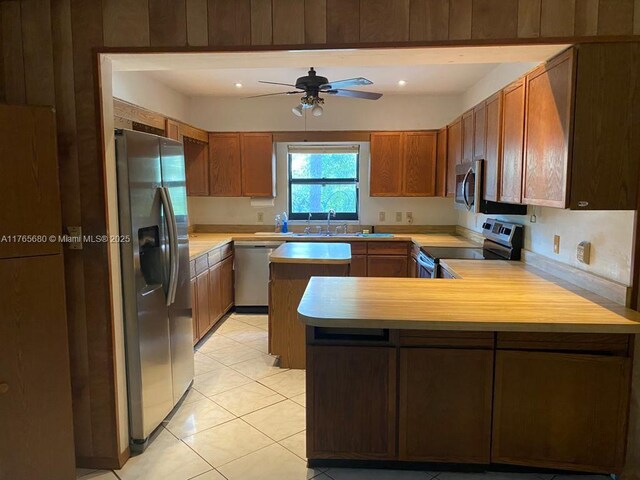 1616 Churchill St, Lake Placid, FL 33852 - kitchen featuring light countertops, a ceiling fan, appliances with stainless steel finishes, and a sink