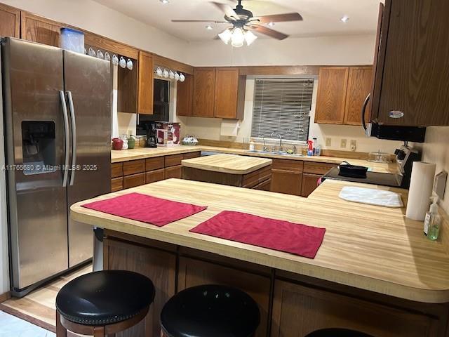 1616 Churchill St, Lake Placid, FL 33852 - kitchen featuring ceiling fan, stainless steel fridge with ice dispenser, electric range oven, a peninsula, and a sink