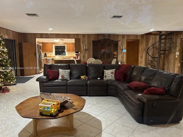 1616 Churchill St, Lake Placid, FL 33852 - living room featuring visible vents, wood walls, and light tile patterned flooring