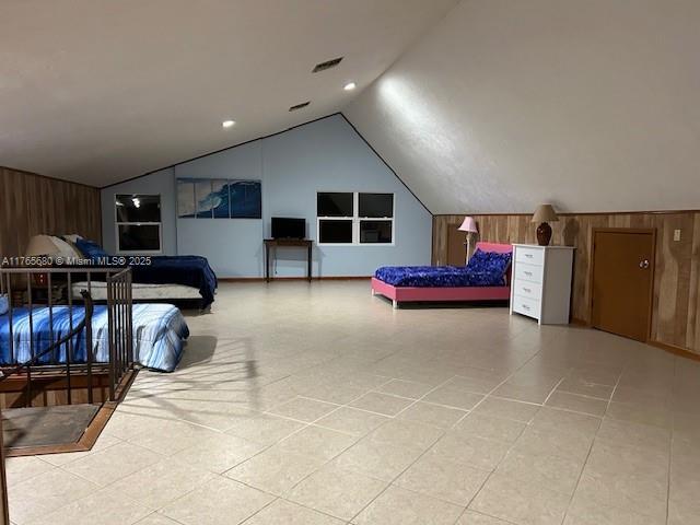 1616 Churchill St, Lake Placid, FL 33852 - bedroom featuring visible vents, wood walls, and vaulted ceiling