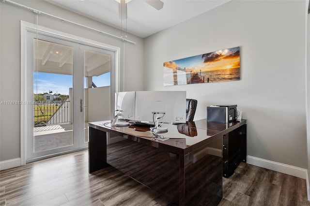 office area featuring wood finished floors, baseboards, and a ceiling fan