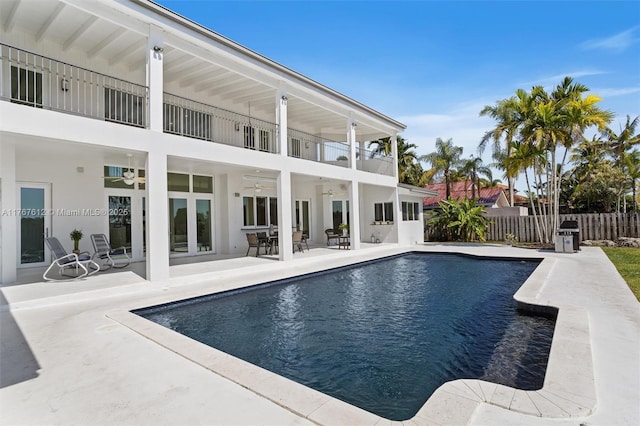 view of pool featuring a ceiling fan, a patio area, a fenced in pool, and fence