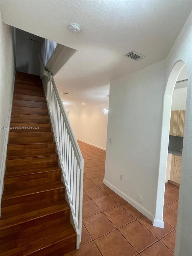 5450 NW 107th Ave Unit 705, Doral, FL 33178 - stairs with tile patterned flooring and arched walkways