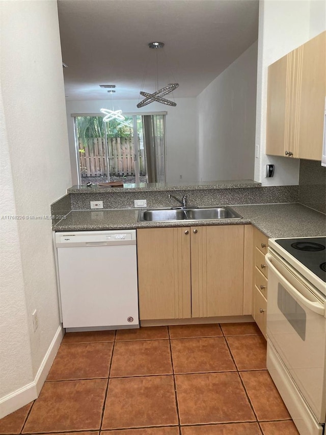 5450 NW 107th Ave Unit 705, Doral, FL 33178 - kitchen with light brown cabinets, light tile patterned floors, a peninsula, white appliances, and a sink