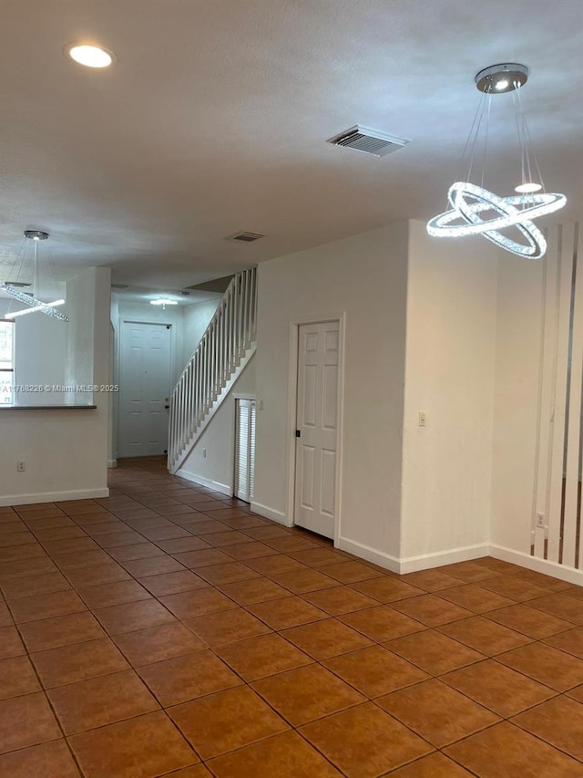 5450 NW 107th Ave Unit 705, Doral, FL 33178 - tiled empty room featuring a chandelier, stairs, and recessed lighting