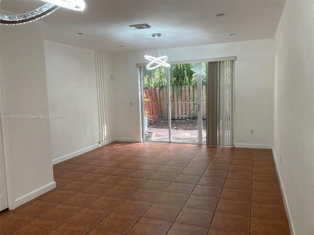 5450 NW 107th Ave Unit 705, Doral, FL 33178 - spare room with an inviting chandelier, visible vents, baseboards, and tile patterned floors
