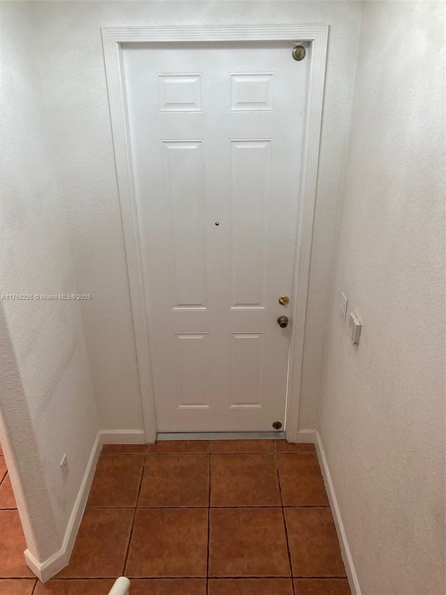 5450 NW 107th Ave Unit 705, Doral, FL 33178 - doorway featuring tile patterned floors and baseboards