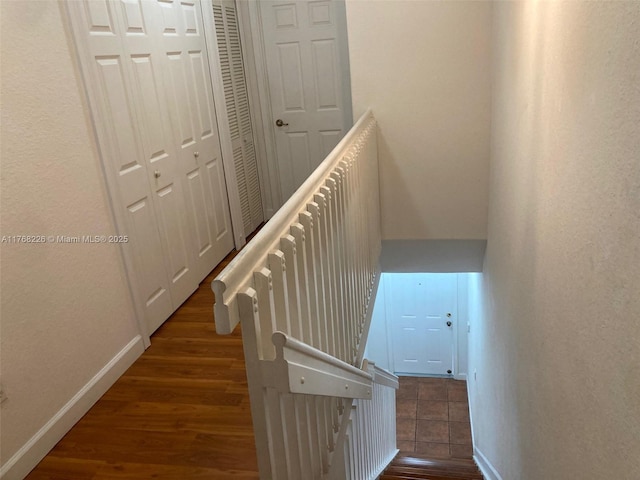 5450 NW 107th Ave Unit 705, Doral, FL 33178 - staircase featuring baseboards and wood finished floors