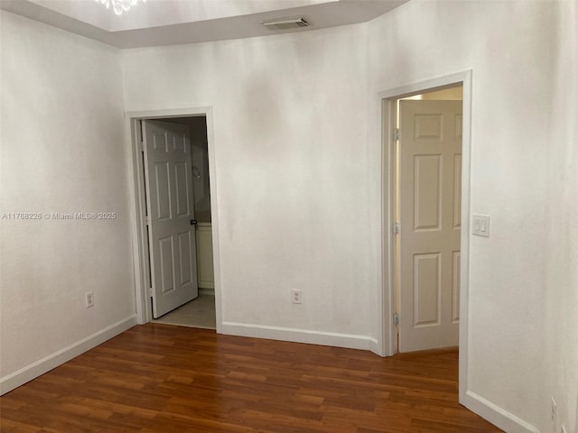 5450 NW 107th Ave Unit 705, Doral, FL 33178 - empty room with visible vents, baseboards, and wood finished floors