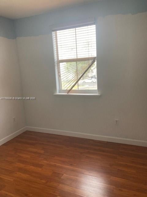 5450 NW 107th Ave Unit 705, Doral, FL 33178 - unfurnished room featuring wood finished floors and baseboards