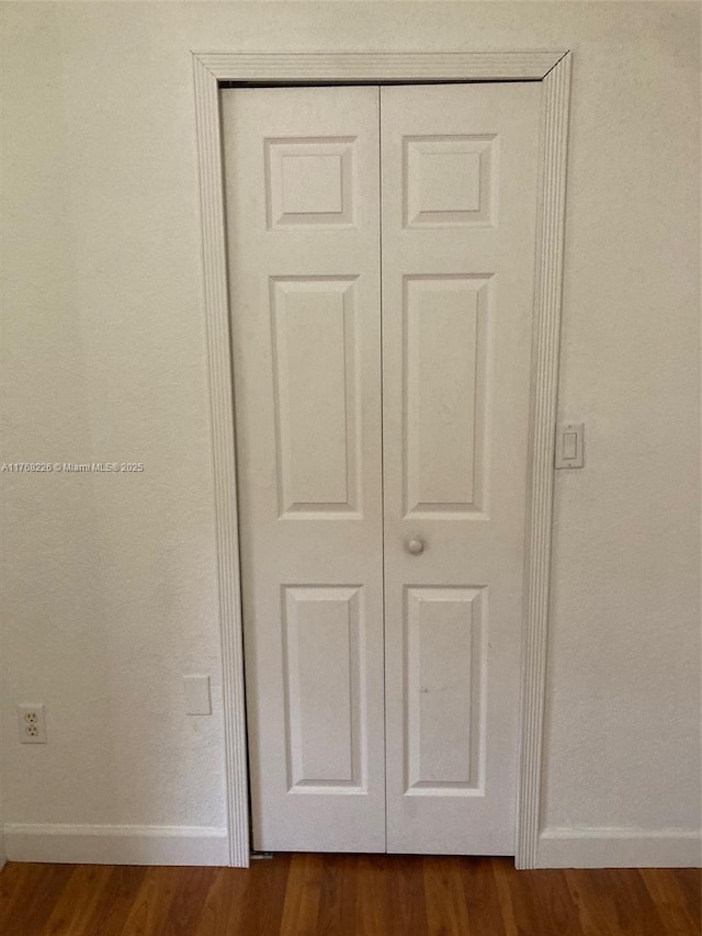 5450 NW 107th Ave Unit 705, Doral, FL 33178 - room details with baseboards and wood finished floors