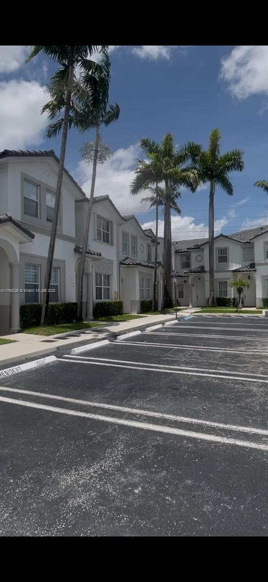 5450 NW 107th Ave Unit 705, Doral, FL 33178 - view of building exterior with a residential view and uncovered parking