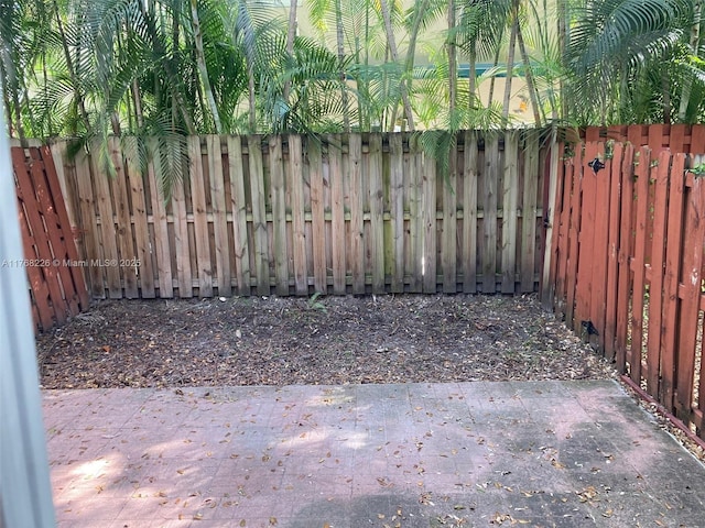 5450 NW 107th Ave Unit 705, Doral, FL 33178 - view of gate with a fenced backyard and a patio area