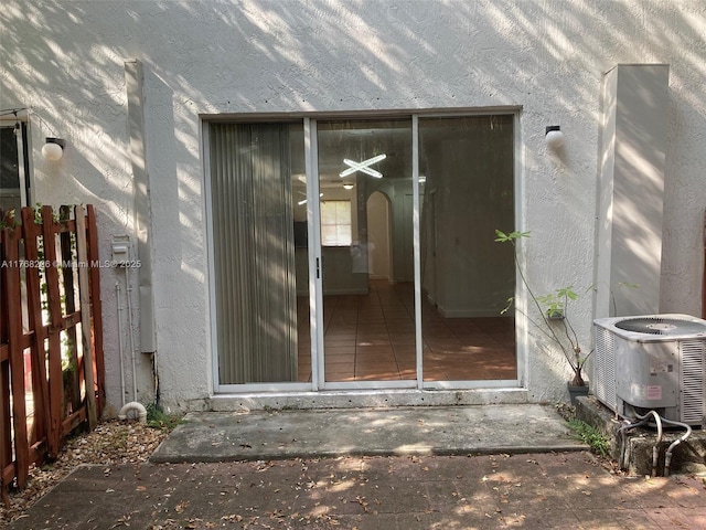 5450 NW 107th Ave Unit 705, Doral, FL 33178 - view of exterior entry with central AC unit, fence, and stucco siding