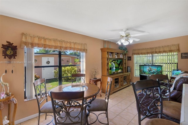 dining room featuring light tile patterned floors, baseboards, and ceiling fan