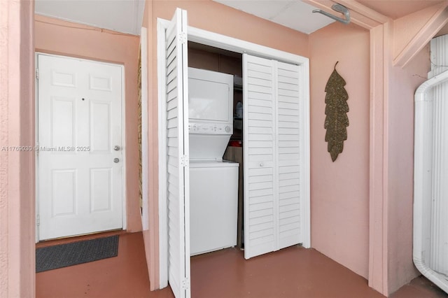 clothes washing area with laundry area and stacked washer and clothes dryer