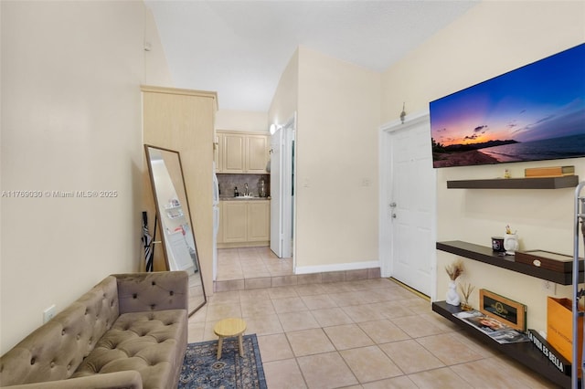 interior space with light tile patterned floors and baseboards