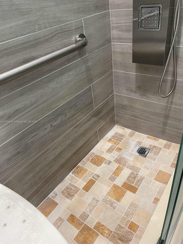 bathroom with tiled shower