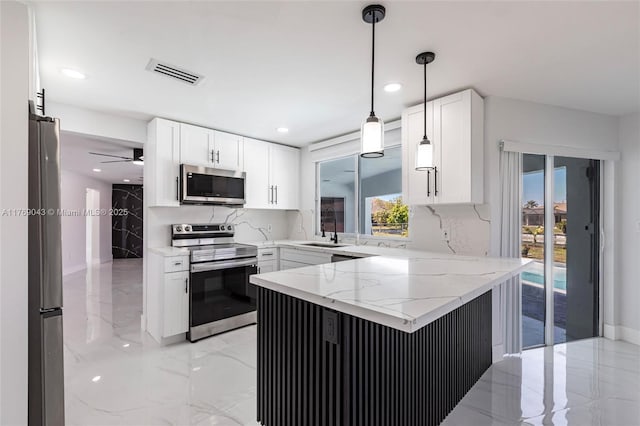 1801 Hancock Bridge Pkwy, Cape Coral, FL 33990 - kitchen with visible vents, appliances with stainless steel finishes, a peninsula, marble finish floor, and white cabinetry