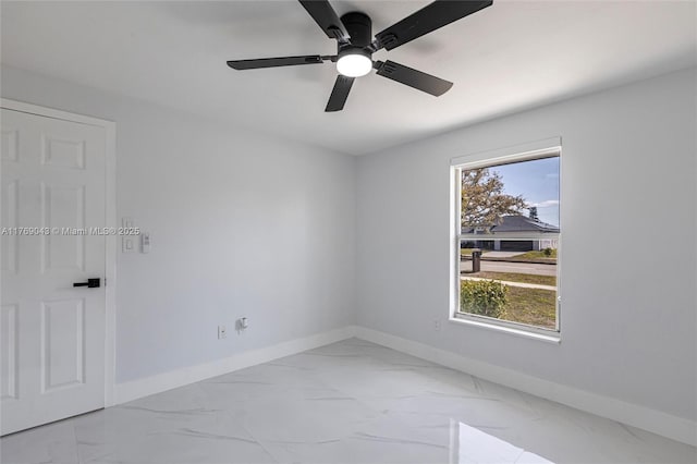 1801 Hancock Bridge Pkwy, Cape Coral, FL 33990 - empty room featuring ceiling fan, a healthy amount of sunlight, marble finish floor, and baseboards