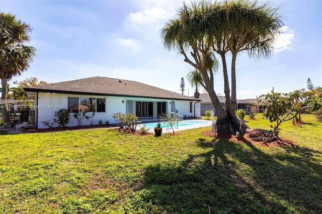 1801 Hancock Bridge Pkwy, Cape Coral, FL 33990 - back of property featuring a lawn, an outdoor pool, and stucco siding