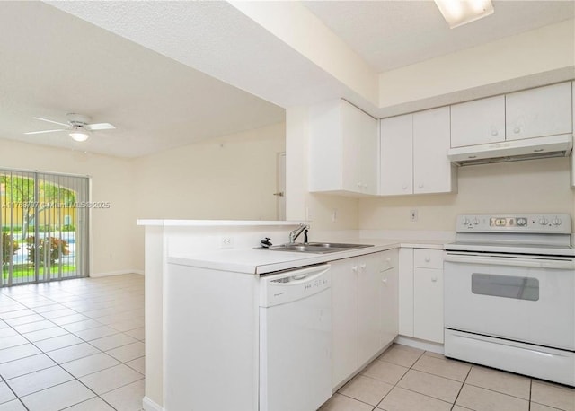 5530 NW 61st St Unit 303, Coconut Creek, FL 33073 - kitchen featuring white appliances, under cabinet range hood, light tile patterned floors, and white cabinetry