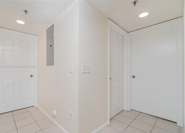 5530 NW 61st St Unit 303, Coconut Creek, FL 33073 - hall featuring light tile patterned floors, electric panel, a textured ceiling, and recessed lighting