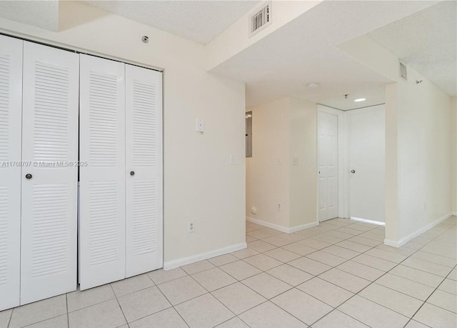 5530 NW 61st St Unit 303, Coconut Creek, FL 33073 - unfurnished bedroom with a closet and light tile patterned floors