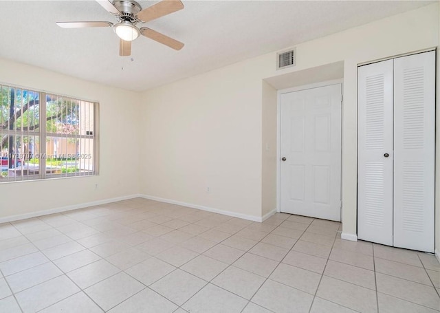 5530 NW 61st St Unit 303, Coconut Creek, FL 33073 - unfurnished bedroom featuring a closet, light tile patterned floors, and a ceiling fan