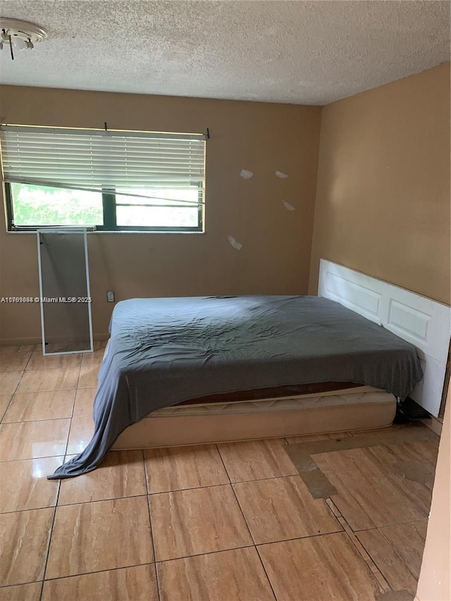 1037 NW 30th St, Miami, FL 33127 - unfurnished bedroom with multiple windows and a textured ceiling