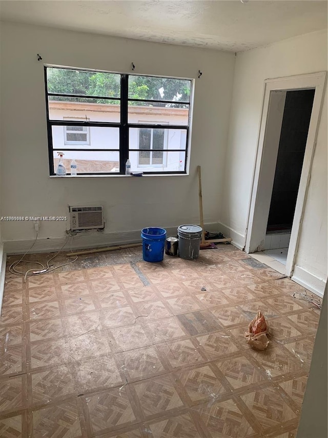 1037 NW 30th St, Miami, FL 33127 - spare room featuring a healthy amount of sunlight, a wall mounted air conditioner, and baseboards