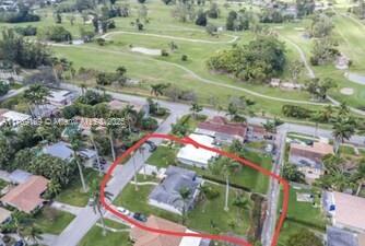 birds eye view of property with view of golf course
