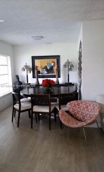 dining space with wood finished floors