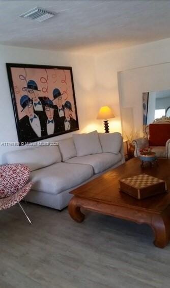 living room featuring wood finished floors and visible vents