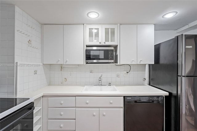 77 Crandon Blvd Unit 2B, Key Biscayne, FL 33149 - kitchen with stainless steel appliances, white cabinetry, decorative backsplash, and light countertops