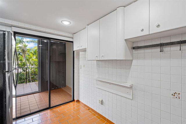 77 Crandon Blvd Unit 2B, Key Biscayne, FL 33149 - kitchen featuring freestanding refrigerator, light tile patterned floors, and white cabinets