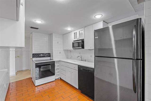 77 Crandon Blvd Unit 2B, Key Biscayne, FL 33149 - kitchen with stainless steel appliances, light countertops, white cabinetry, tasteful backsplash, and recessed lighting