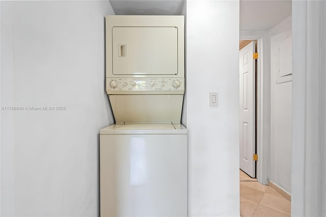 77 Crandon Blvd Unit 2B, Key Biscayne, FL 33149 - washroom with stacked washer / drying machine and light tile patterned floors