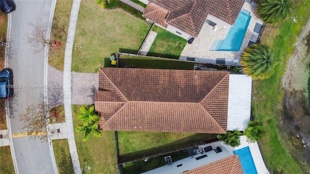 mediterranean / spanish house with a front yard, a tile roof, fence, stucco siding, and decorative driveway